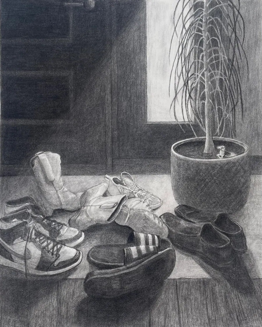 Charcoal drawing of a heap of kicked-off sneakers and shoes on the floor inside a front door, beside a tall potted plant lit by a window.